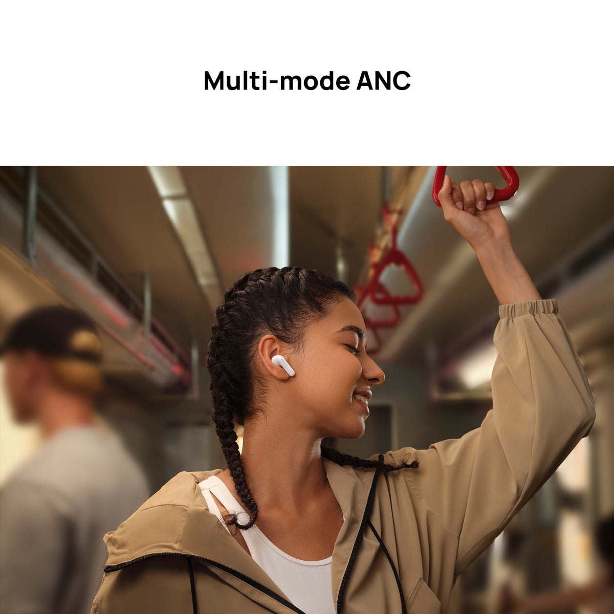 Woman wearing wireless earbuds on a subway train with 'Multi-mode ANC' text above.