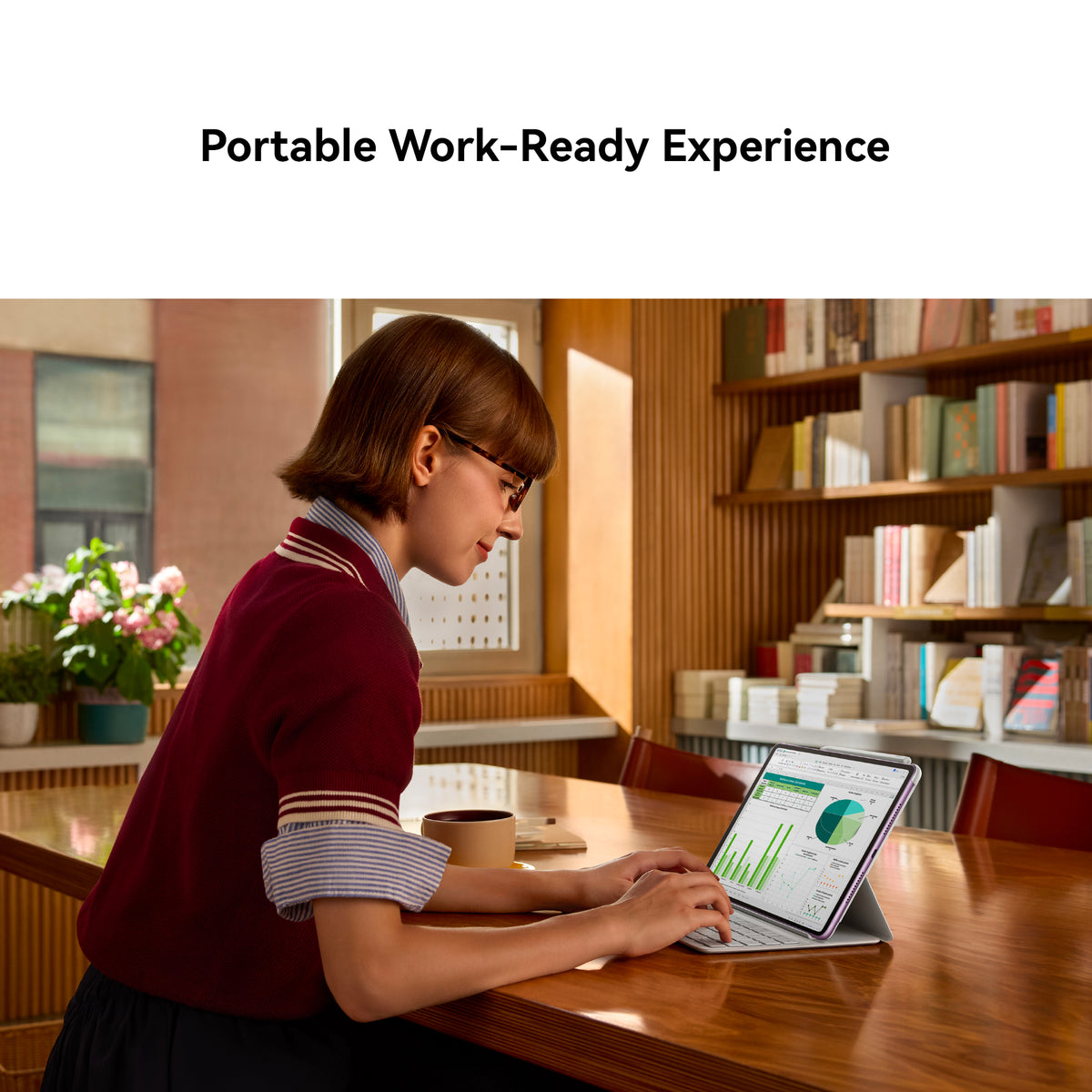 A woman in a maroon sweater sits at a wooden table using a tablet in a warm, book-filled study. The text 'Portable Work-Ready Experience' appears at the top of the image.