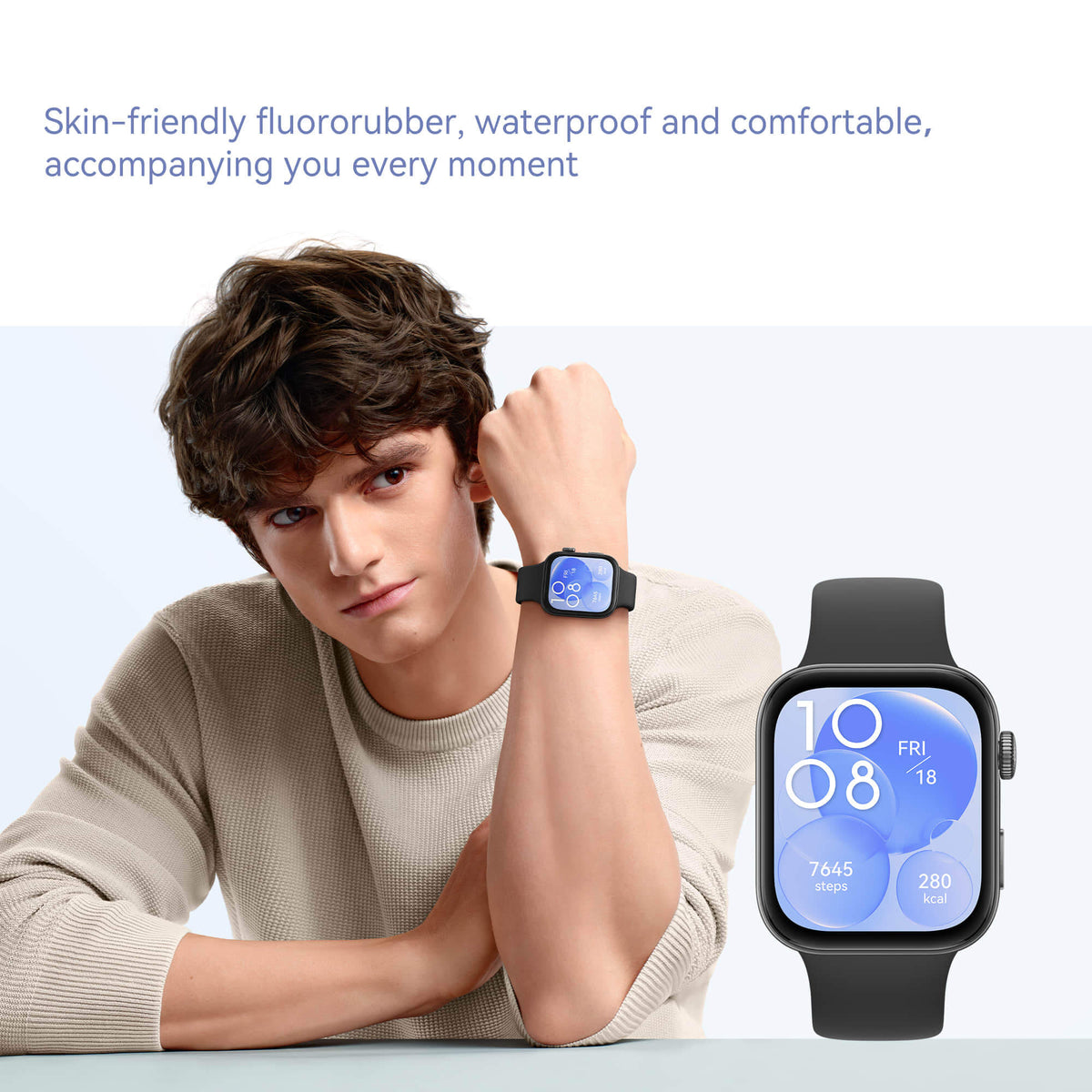 Person wearing a smartwatch with a close-up of the watch face on a light background
